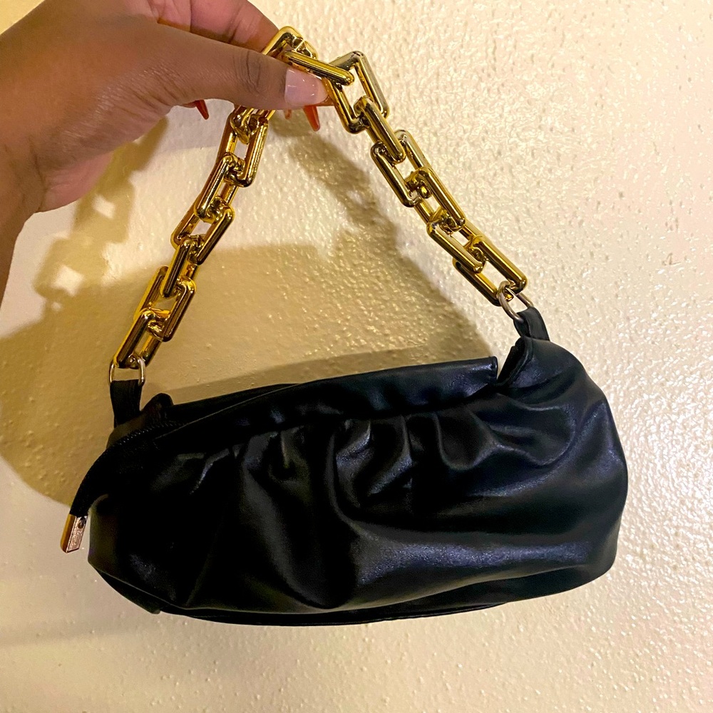 Black bag with gold chain. Love this bag so much. Used it in 2 photo shoot’s.
